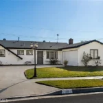 Real Estate house with white exterior and dark trim