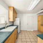 Spacious kitchen with light wood cabinets in California.